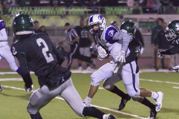 It took four Dinuba Emperors to bring down Lemoore's Brandon Hargrove in Thursday's Central Section, Division II playoff match. The Tigers lost 35-27 to end their season.